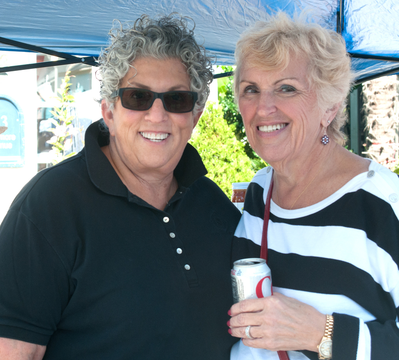 Eileen Siner, left, and Sandir Riddell enjoy the day during the CAMP Rehoboth Block Party. BY DENY HOWETH